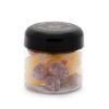 CBD sour gummies in a clear jar with black lid, colorful and sugar-coated.